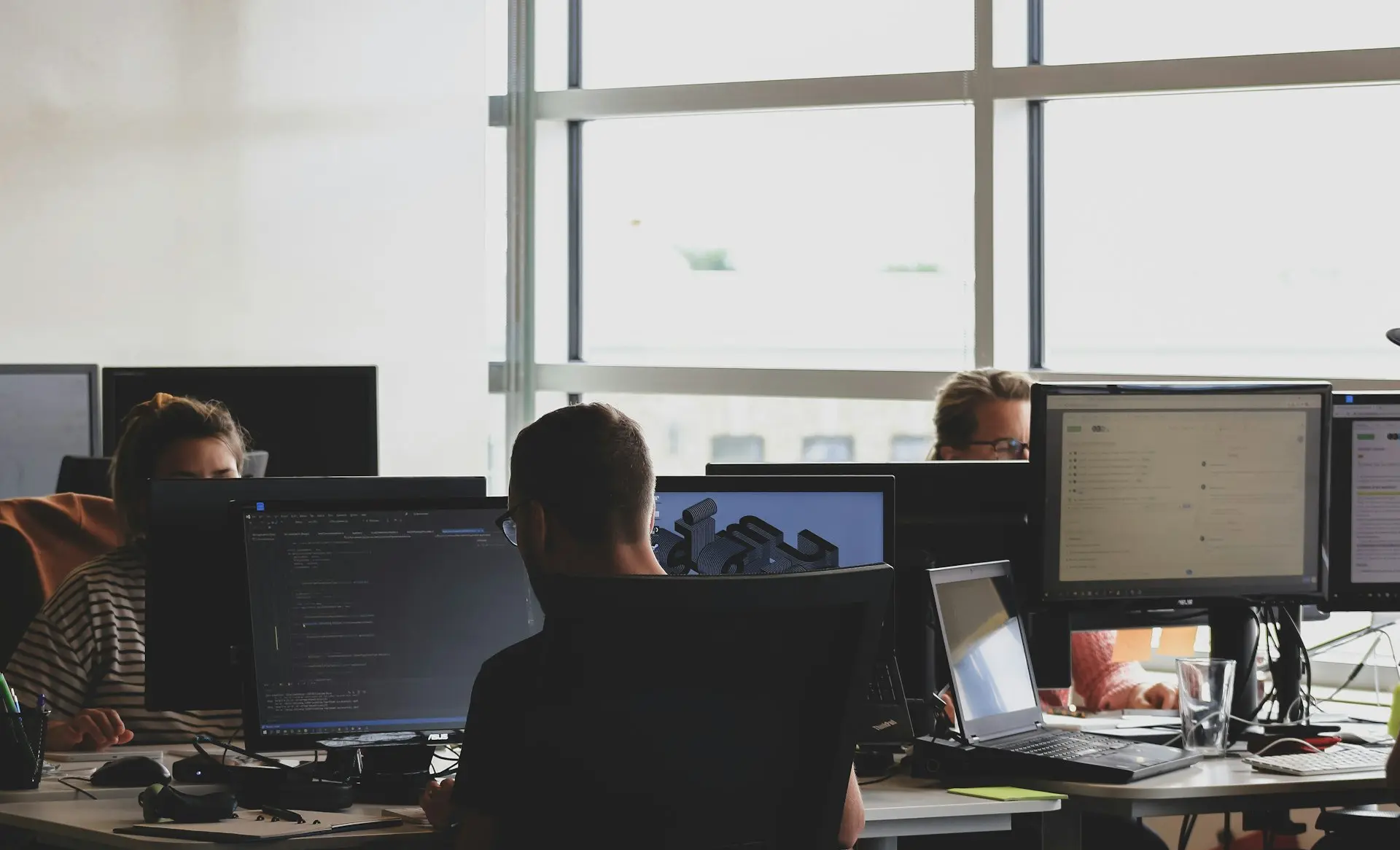 people sitting on chair in front of computer monitor
